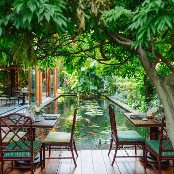 Garden-side tables beside the restaurant pond